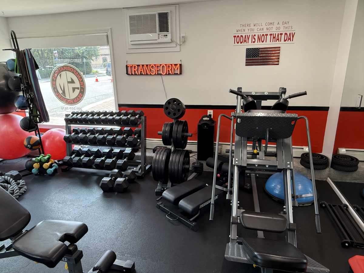 Inside the private personal training studio in Midland Park, NJ — dumbbell wall and training equipment, one client at a time